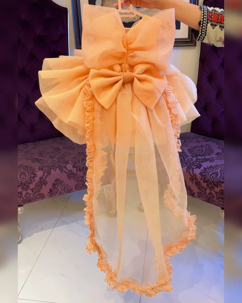 Peach Organza High-Low Dress with Oversized Bow & Ruffled Train – Baby Girl Party Frock